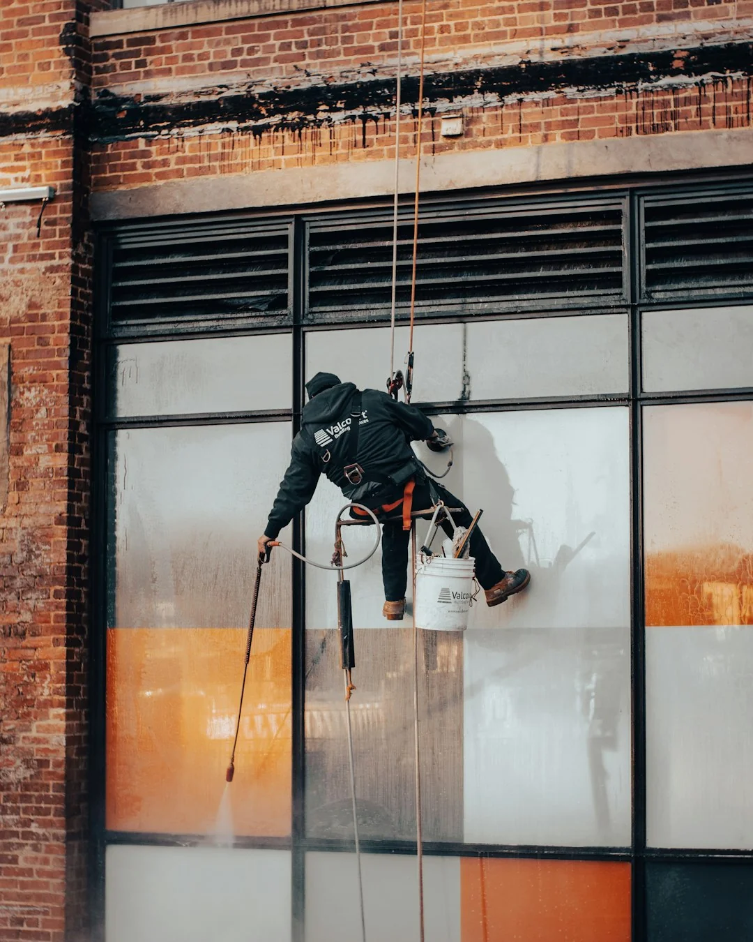 When renovating a home, you should use a damp sponge or cloth to clean dust collected on a window sill, as the dust may contain asbestos or lead-based paint. Home maintenance is an ongoing process for any homeowner, and here we see an African- American woman who’d taken a damp sponge to her window’s frame, in order to remove accumulated dust particulates. Note how the homeowner had donned a pair of waterproof gloves, a facemask, and a pair of goggles, prior to beginning this task.